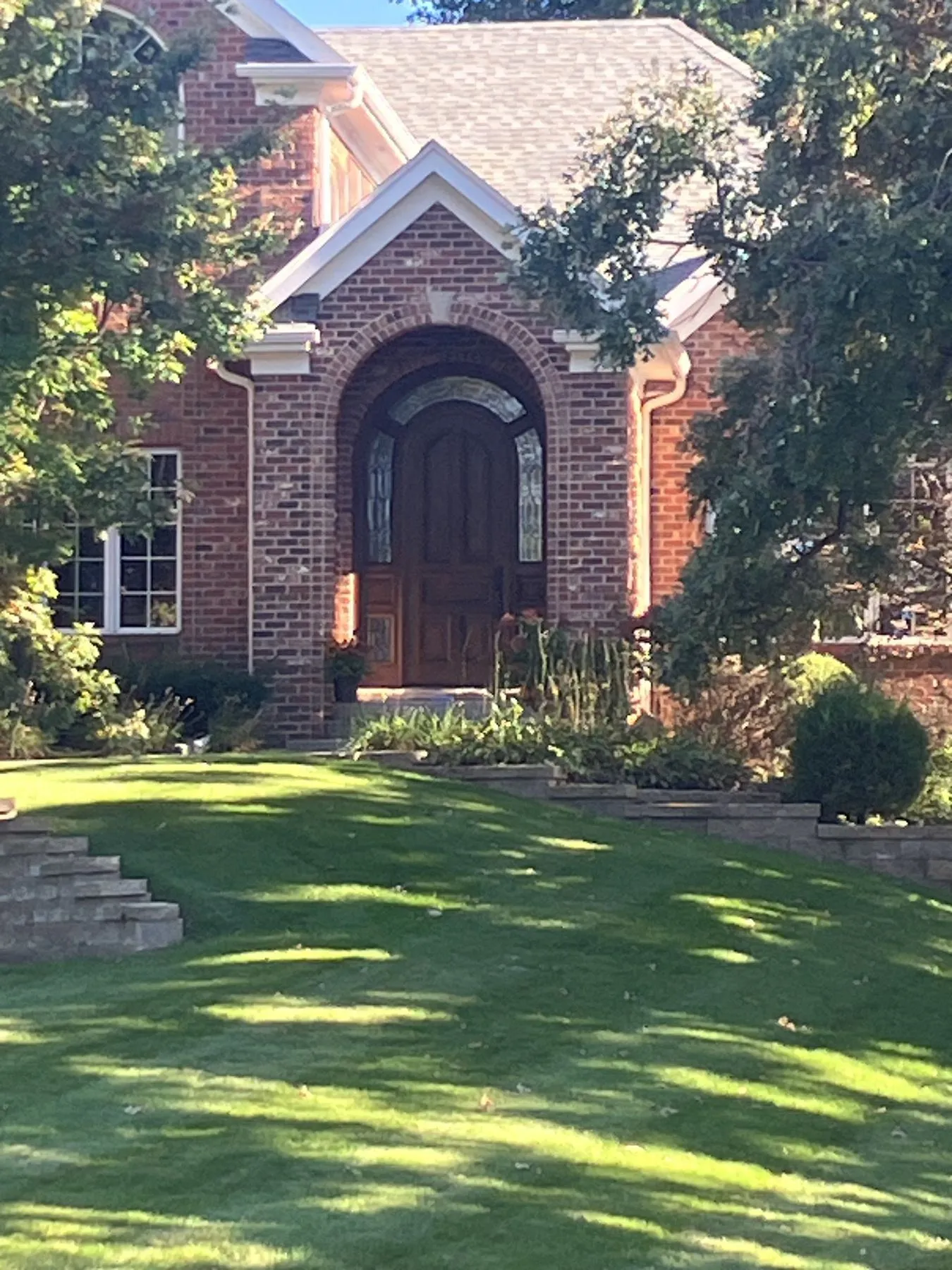 Close view of the arched front door and entry roof