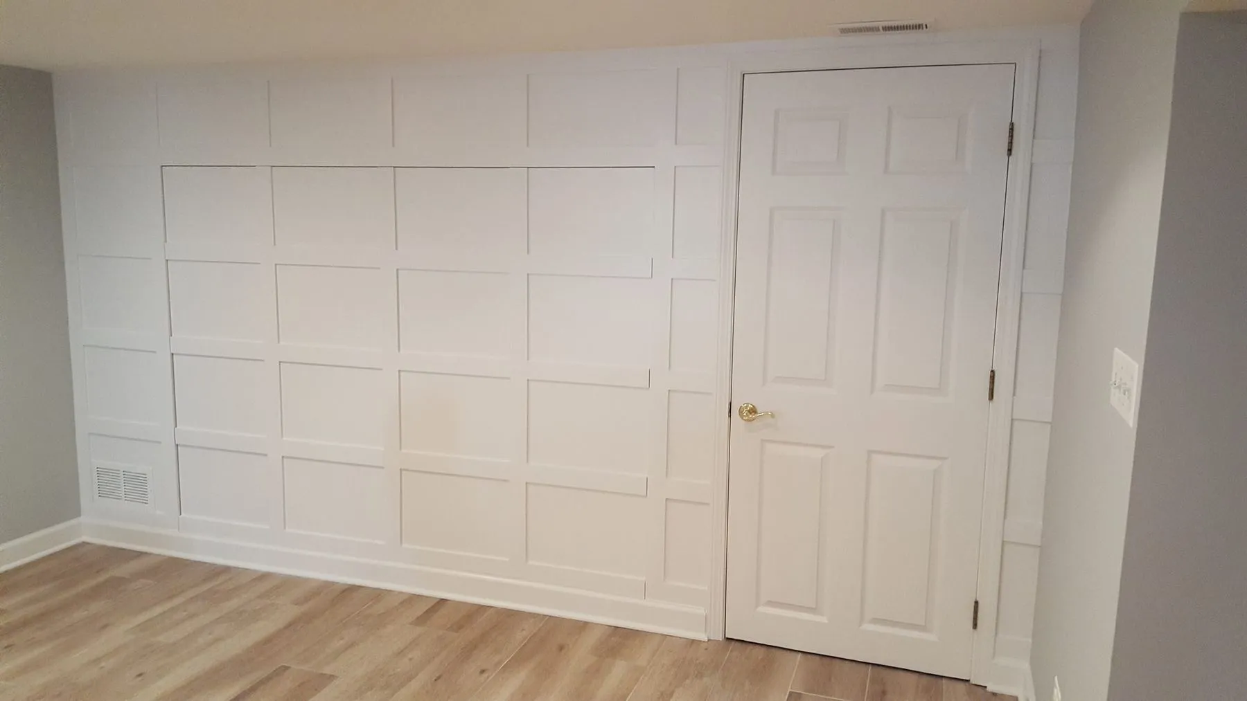 Paneled wall with the bed folded away
