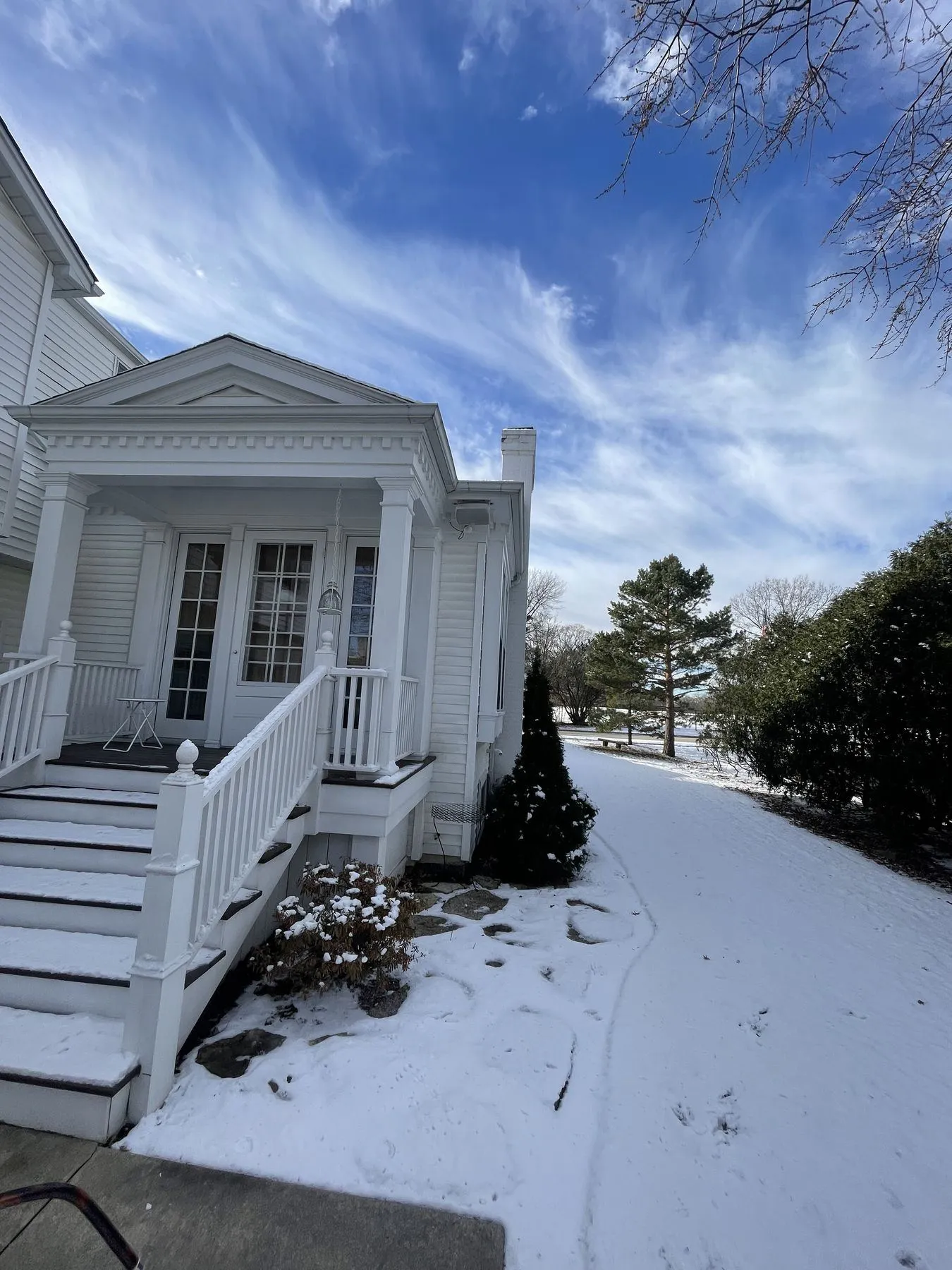 Covered entry with a pediment, French doors, and new steps